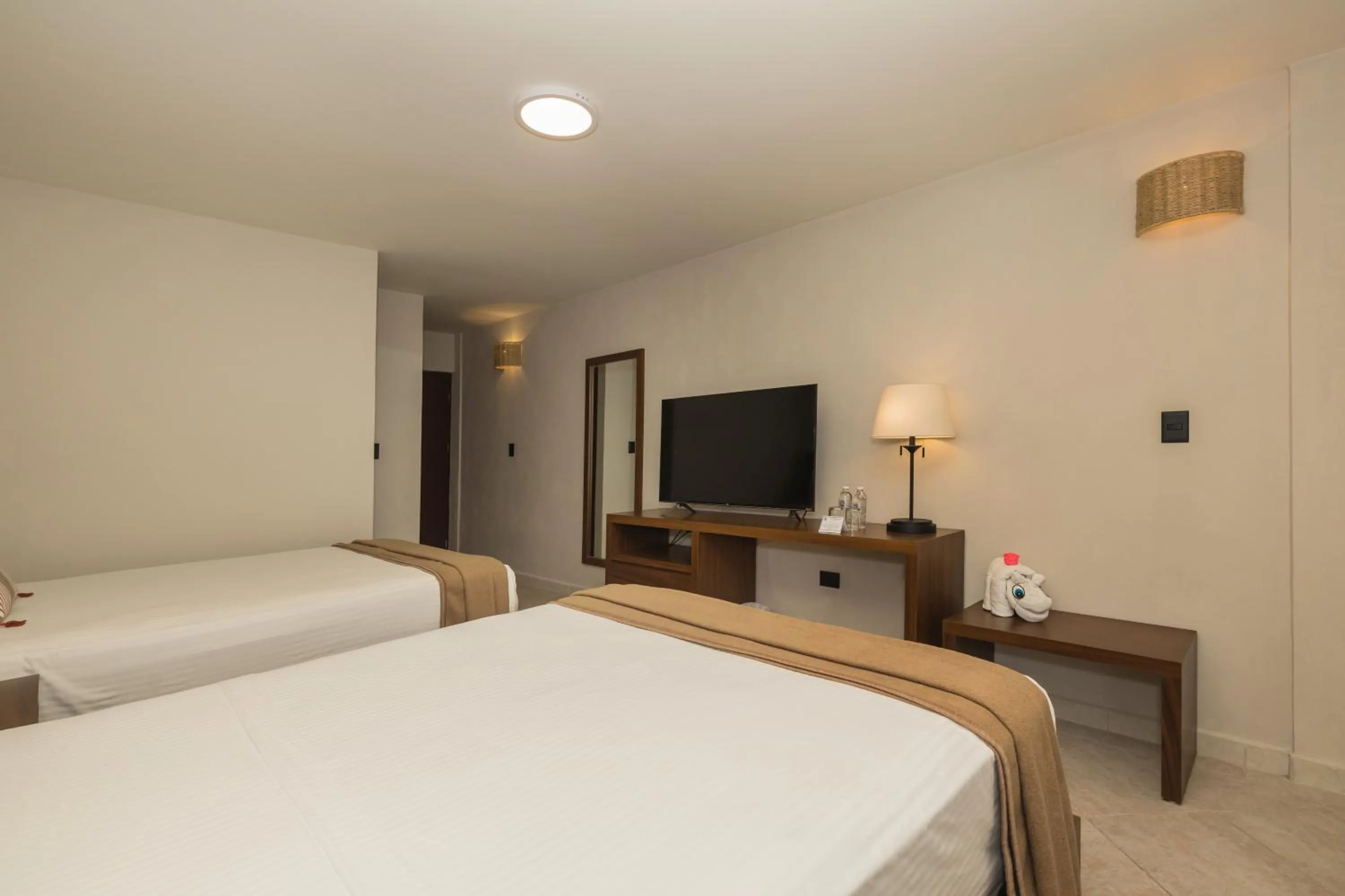 Bed in Casa del Mar Cozumel Hotel & Dive Resort with free access to an exclusive beach club