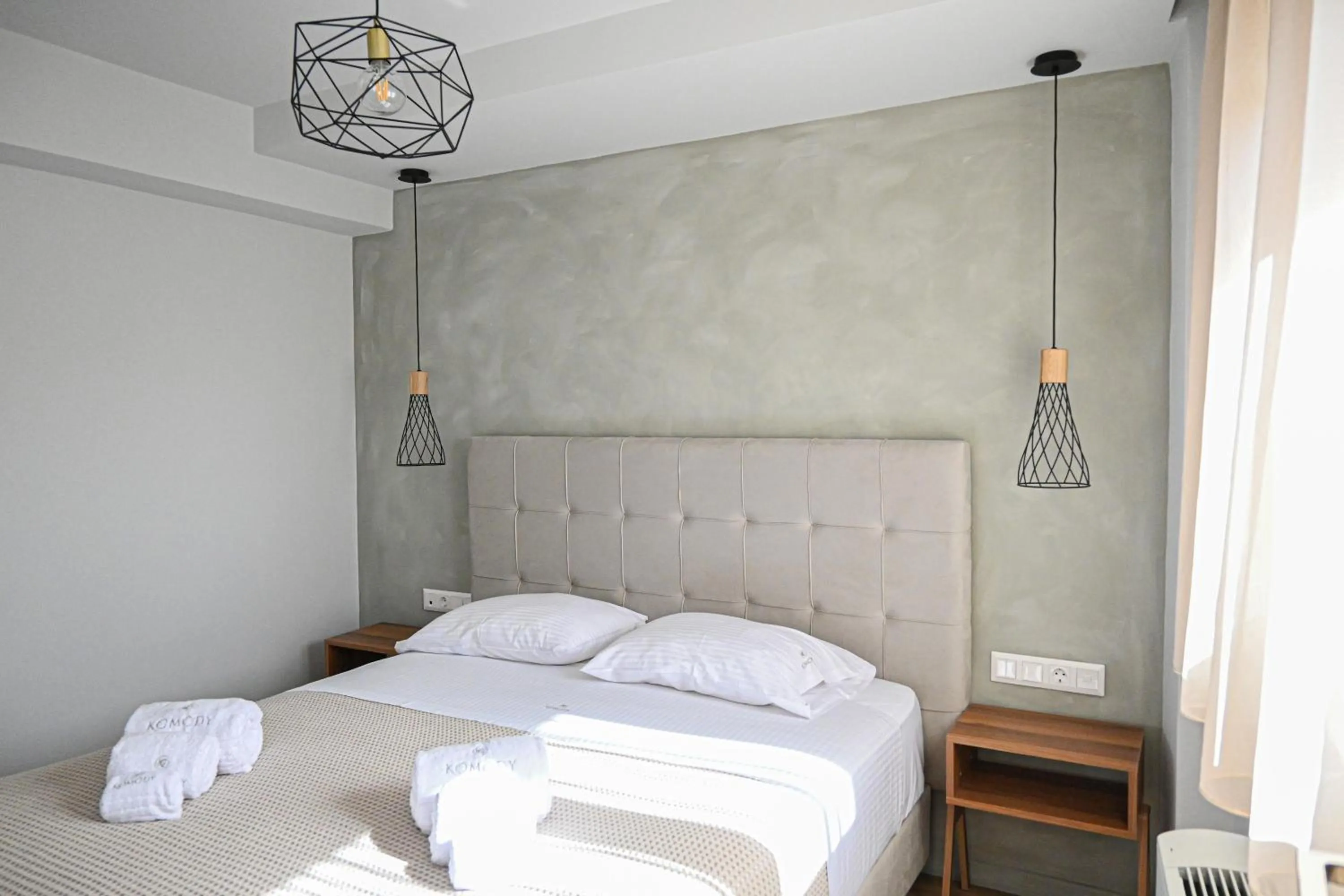 Bed in Komody Apartments