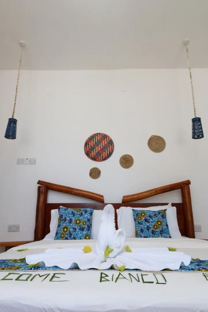 Bed in BIANCO AZZURRO Hotel & Restaurant