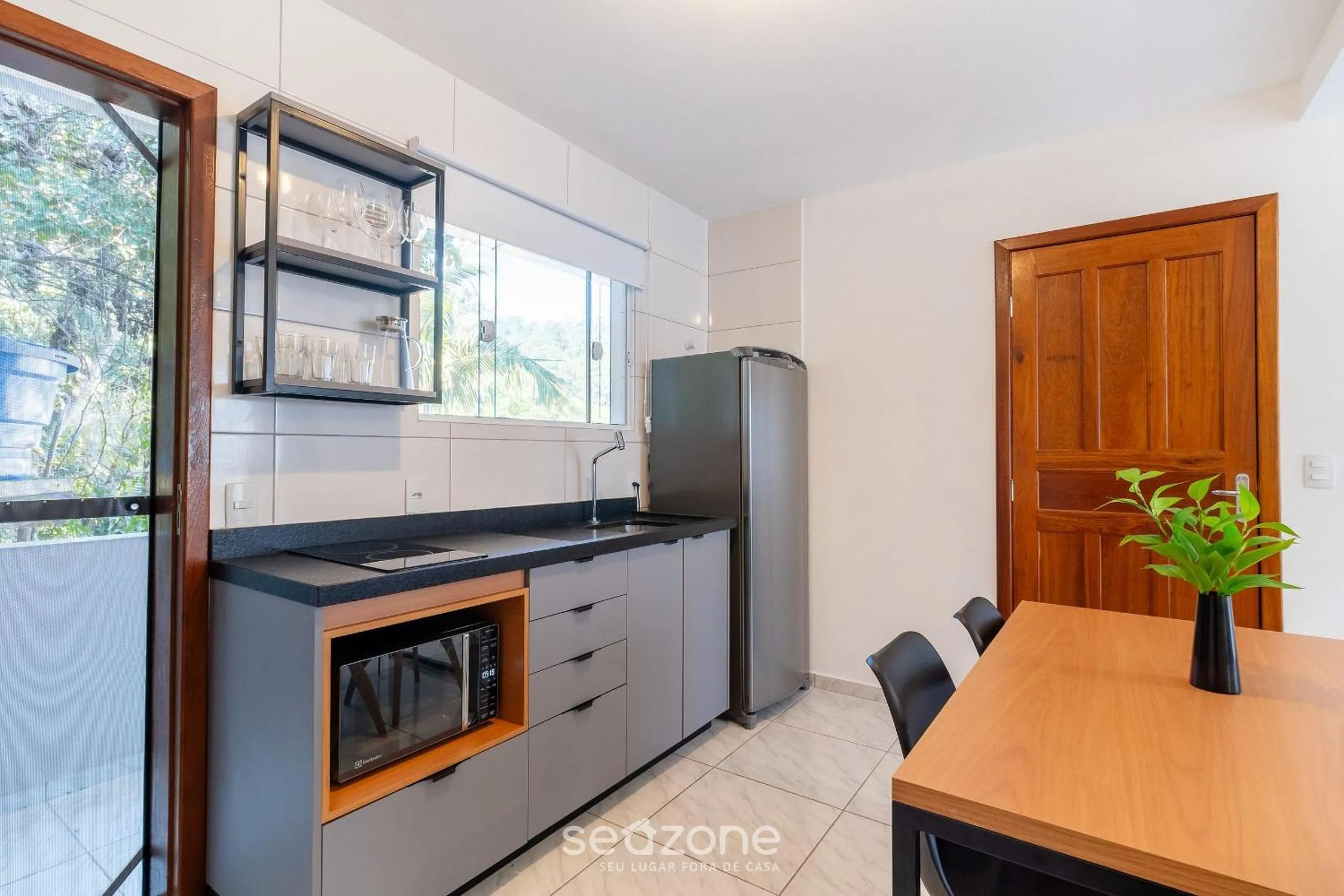 Kitchen or kitchenette in Apartamentos em Jurerê - JMA