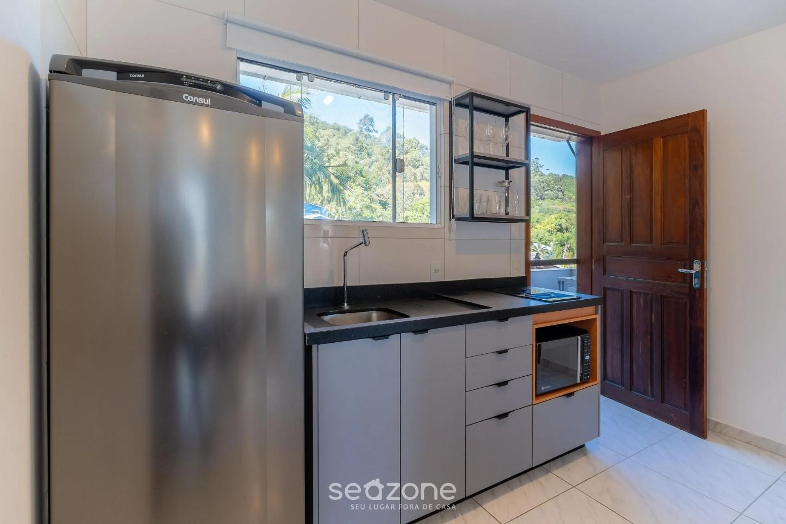 Kitchen or kitchenette in Apartamentos em Jurerê - JMA