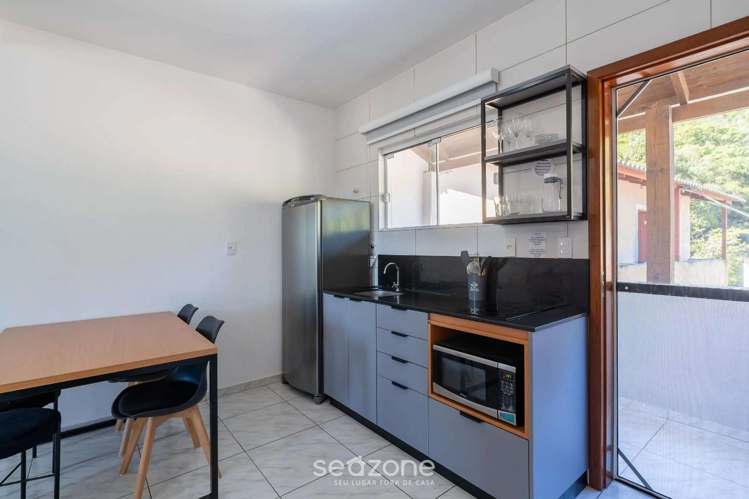 Kitchen or kitchenette in Apartamentos em Jurerê - JMA