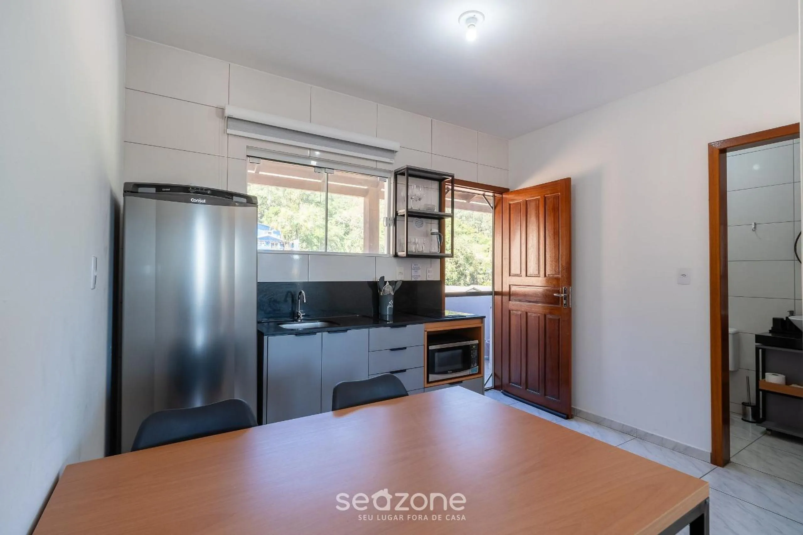 Kitchen or kitchenette in Apartamentos em Jurerê - JMA