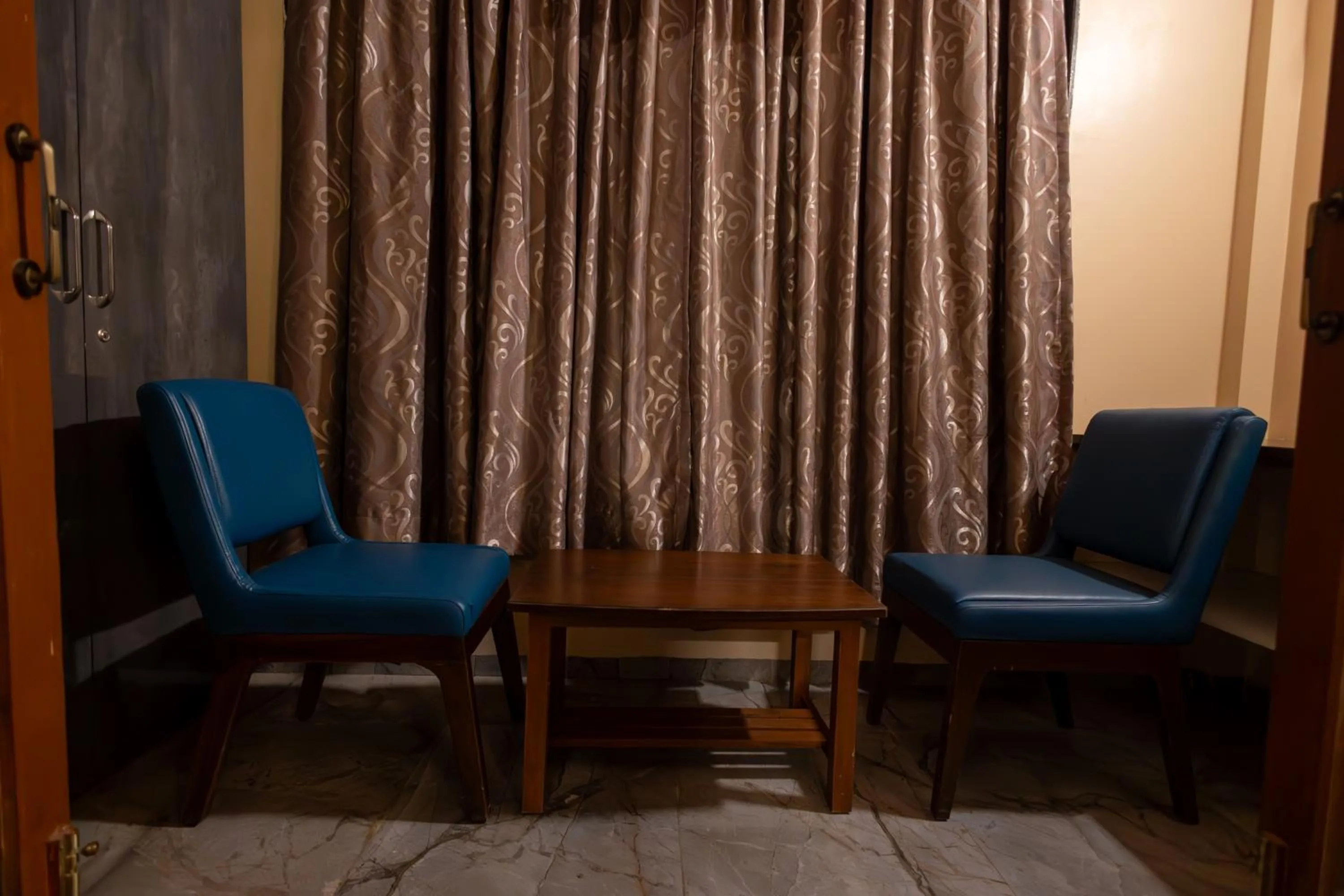 Seating area in Freesia Resort by Express Inn