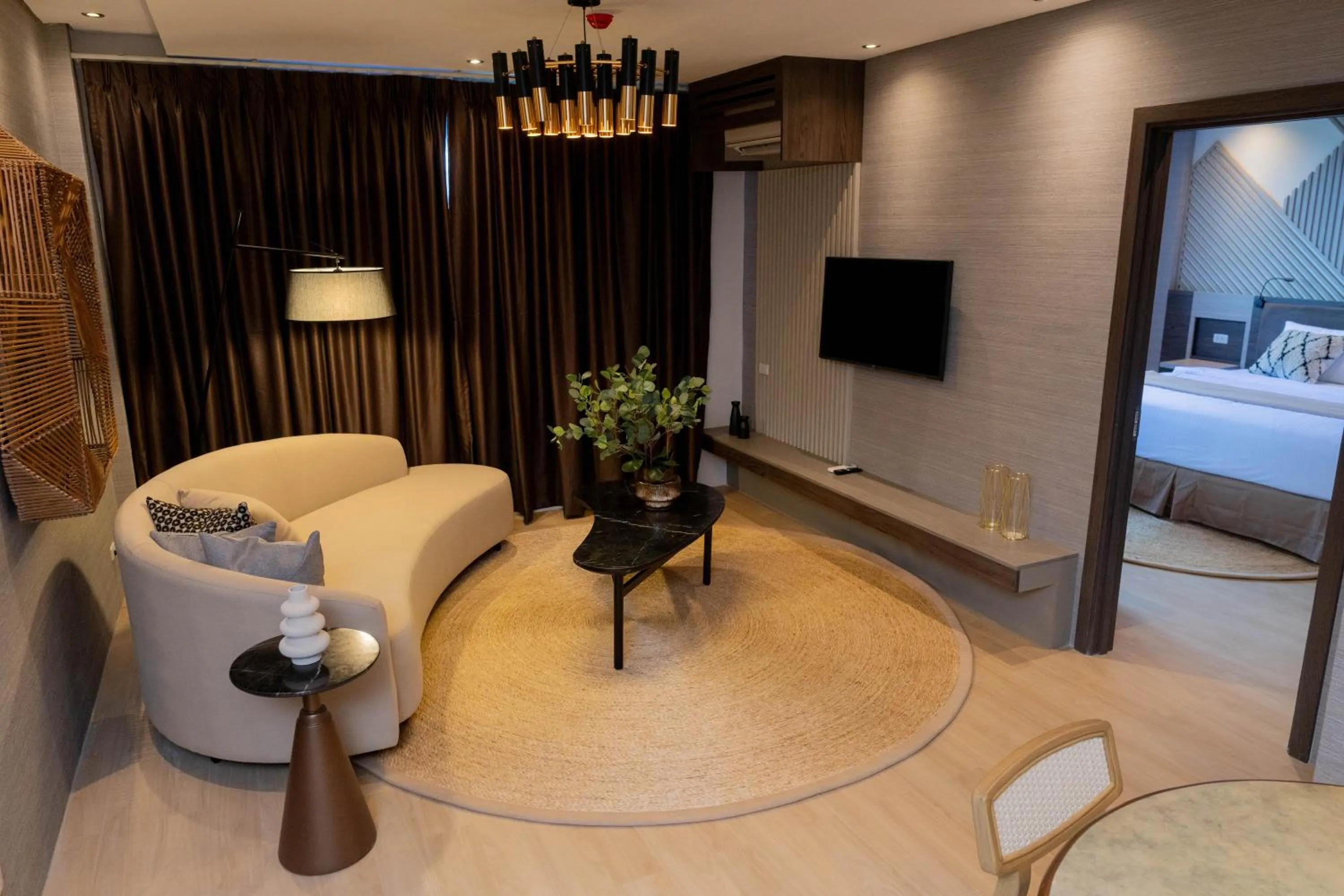 Communal lounge/ TV room, Bed in Adelina Hotel and Suites