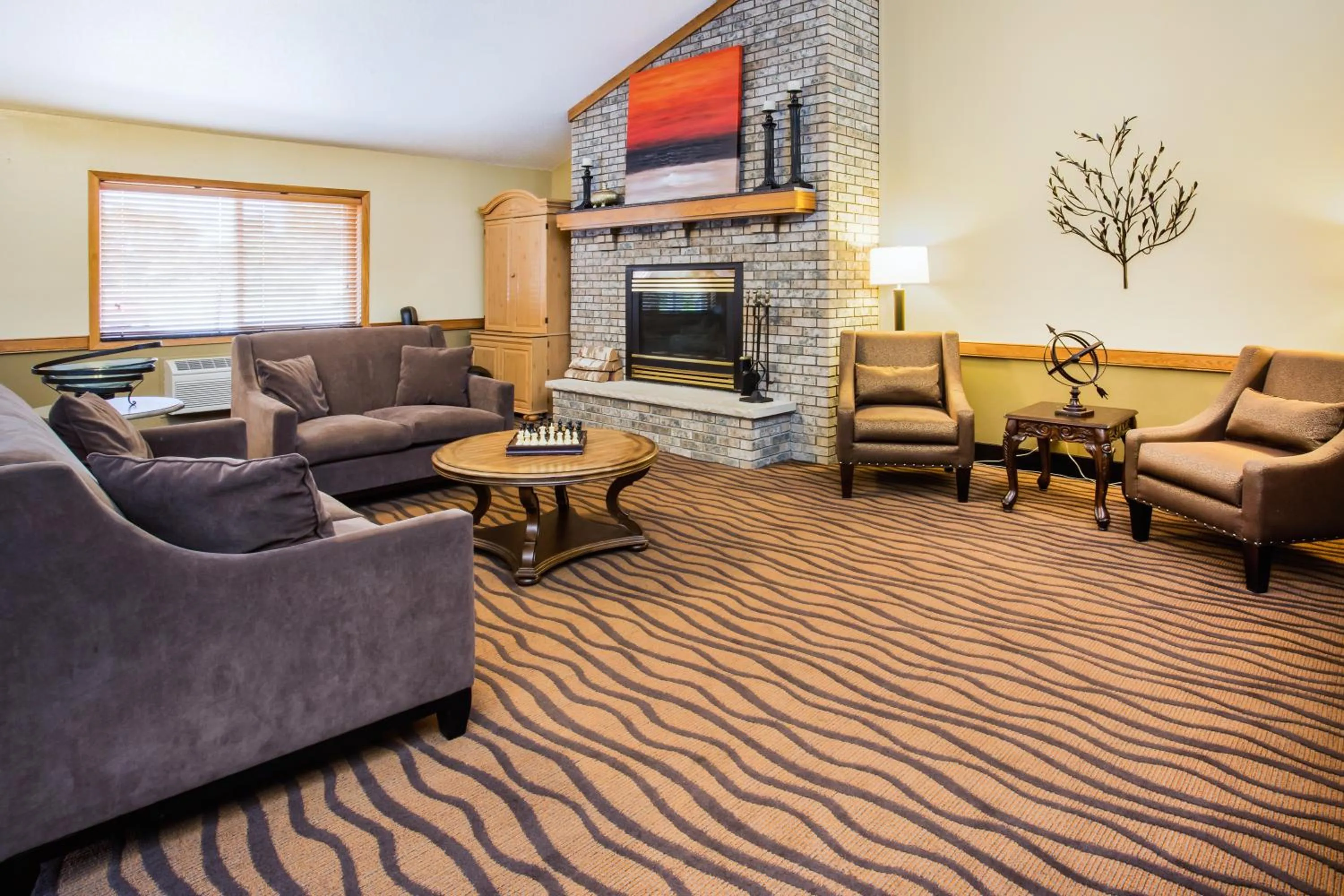 Communal lounge/ TV room in AmericInn by Wyndham Menomonie