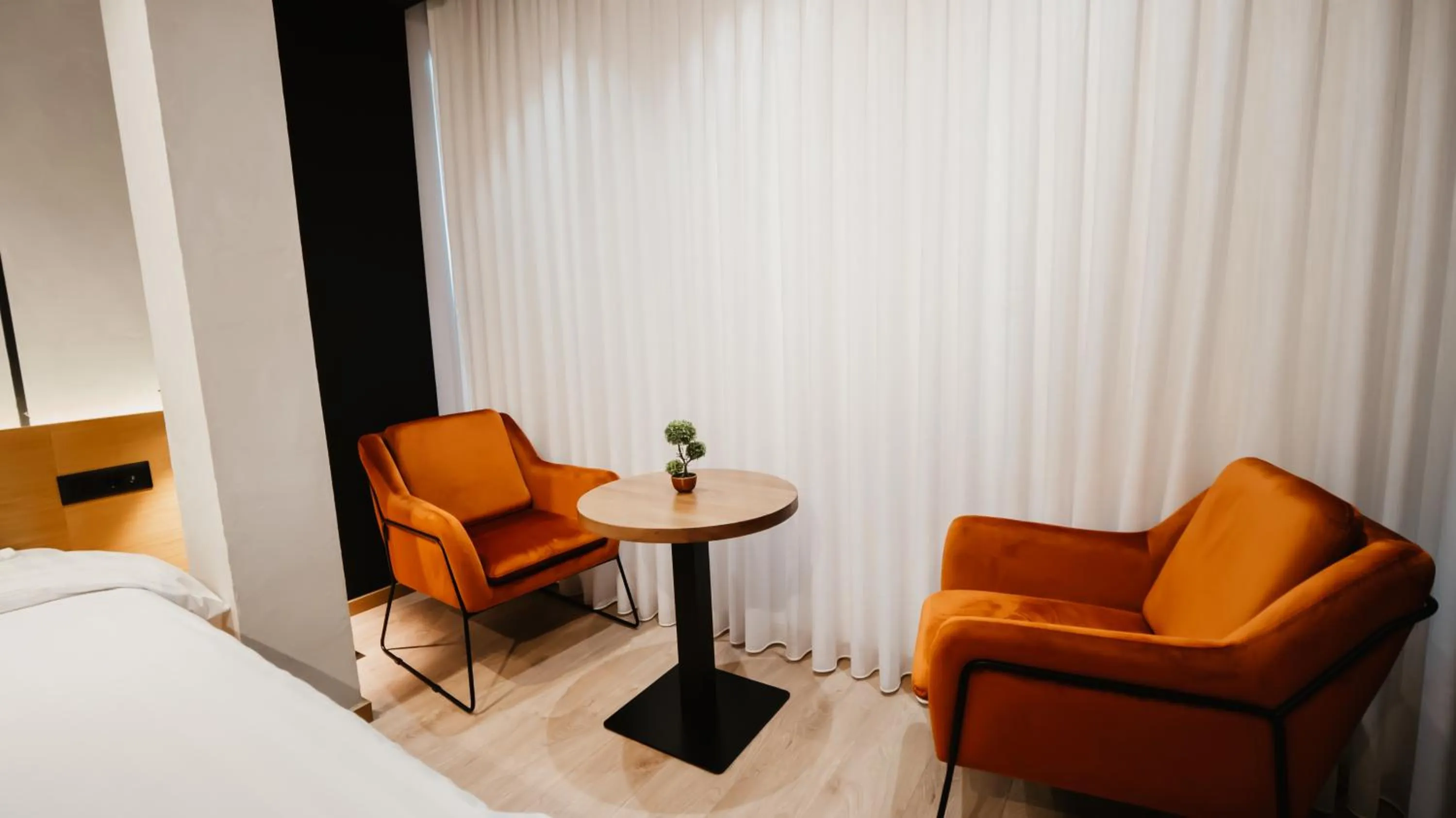 Seating area, Bed in BAZ'HUR Boutique Hotel