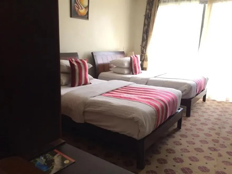 Bed in Hotel Karisimbi