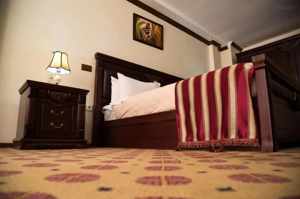 Bed in Hotel Karisimbi