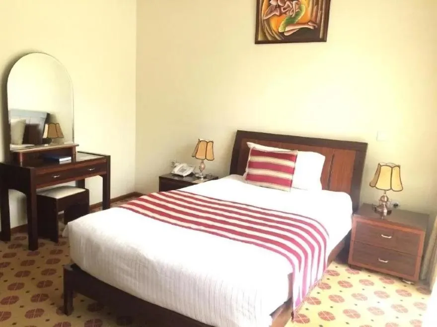 Bed in Hotel Karisimbi