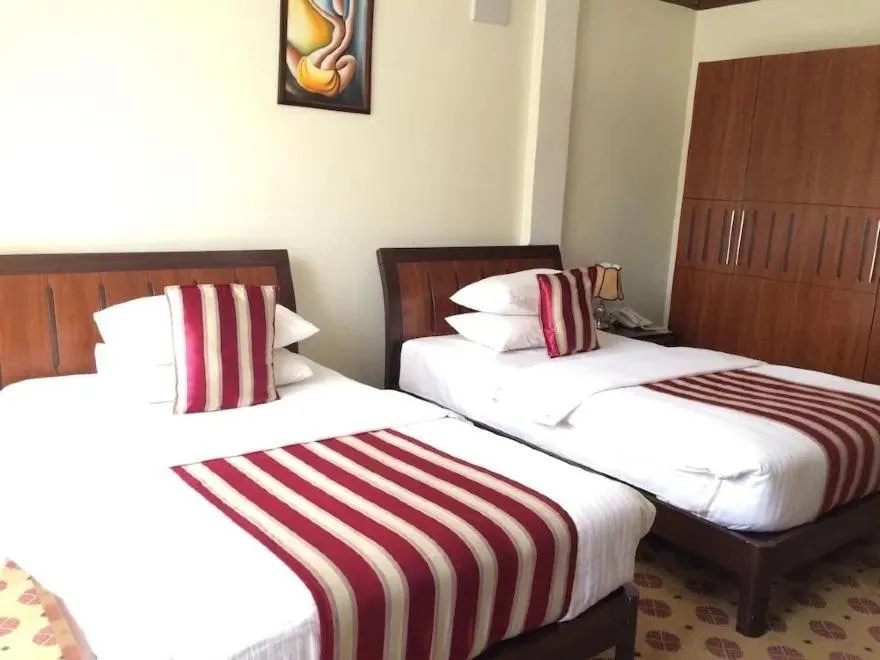 Bed in Hotel Karisimbi