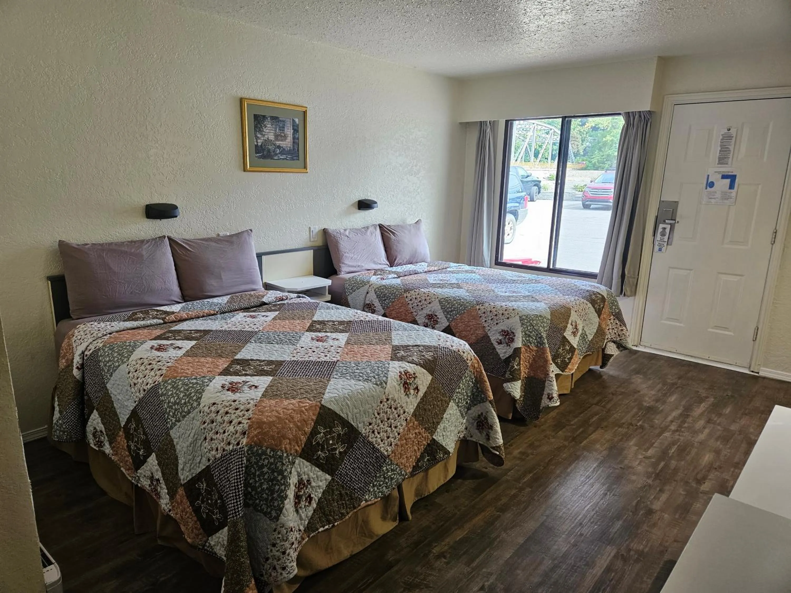 Bed in Granby River Inn & Suites