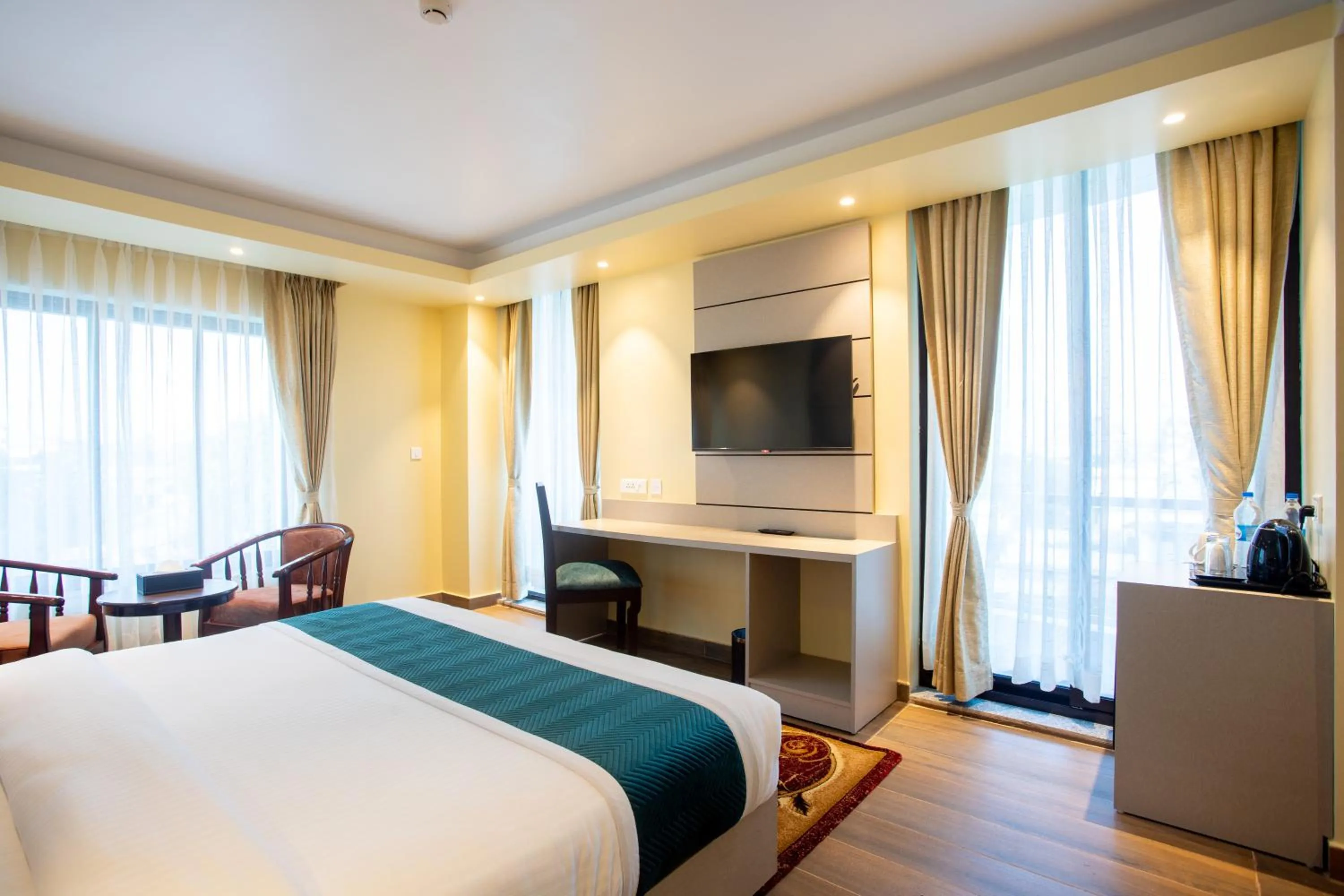 Communal lounge/ TV room, Bed in Bhairahawa Garden Resort