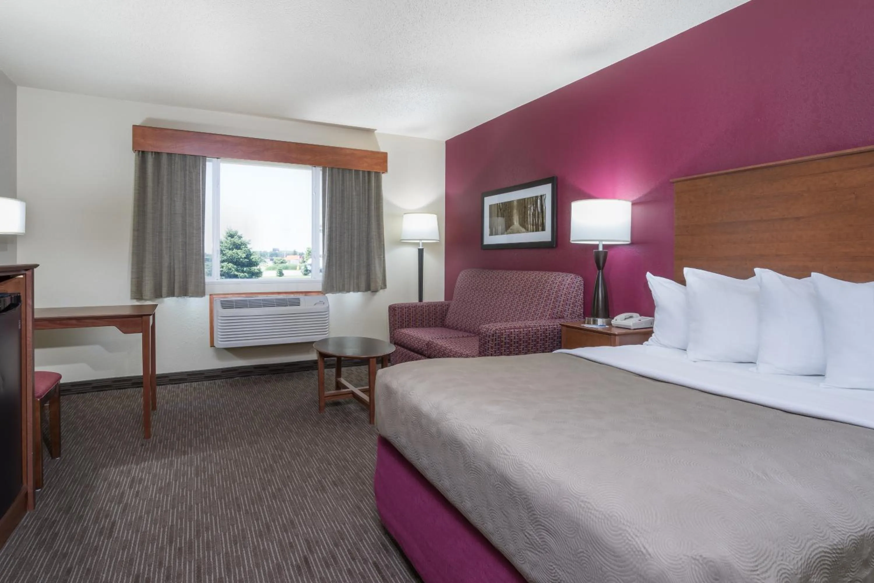 Bed in AmericInn by Wyndham Baldwin