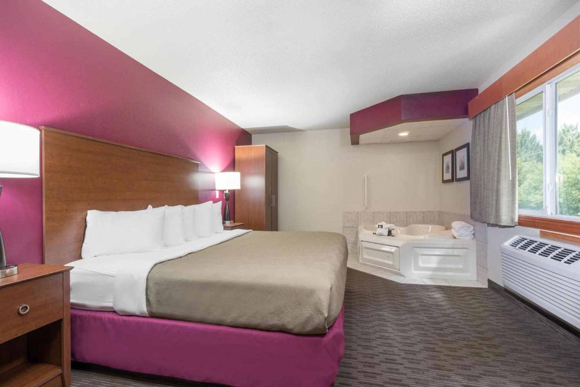 Bed in AmericInn by Wyndham Baldwin