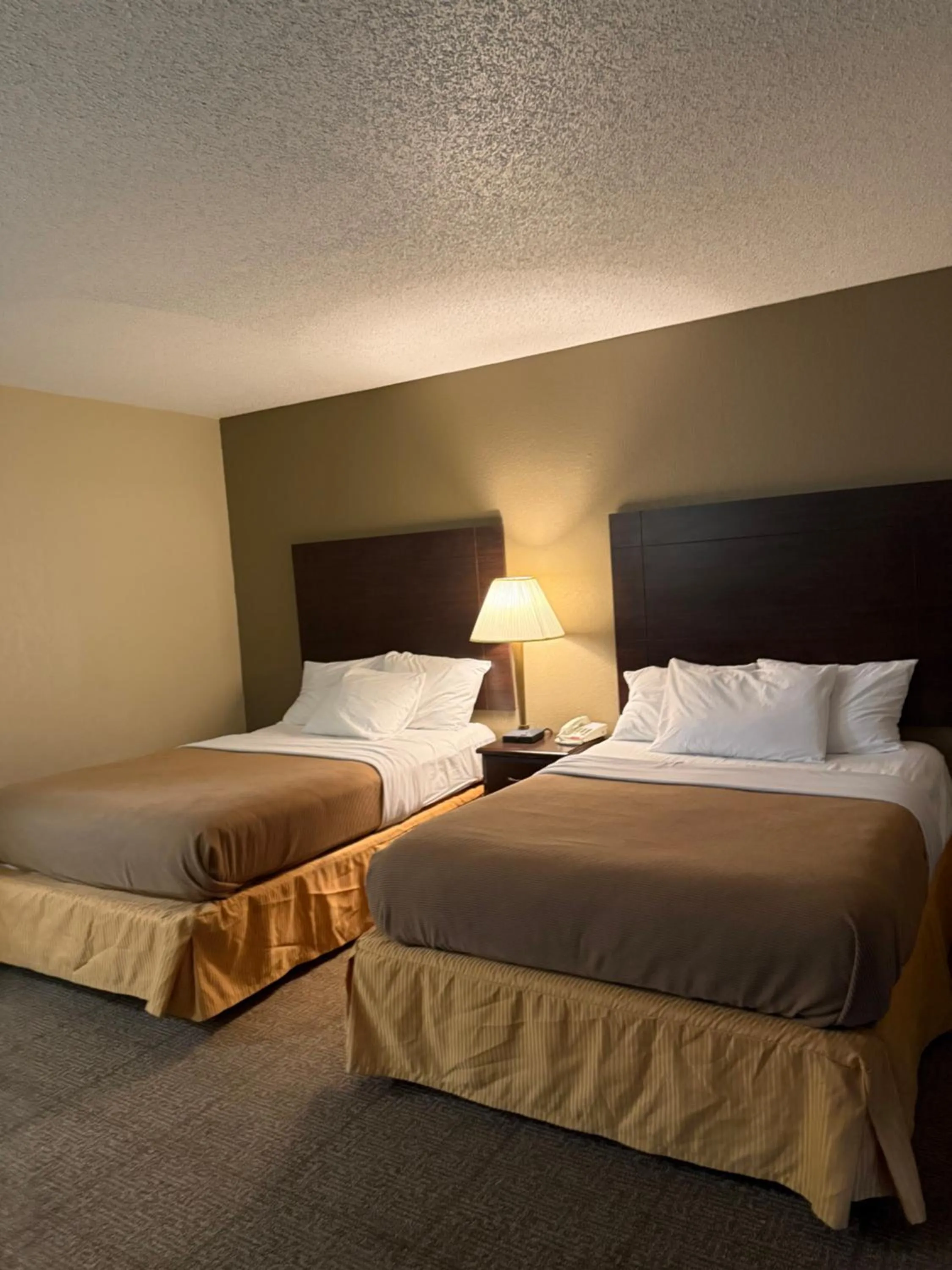 Bed in Clinton Inn & Suites