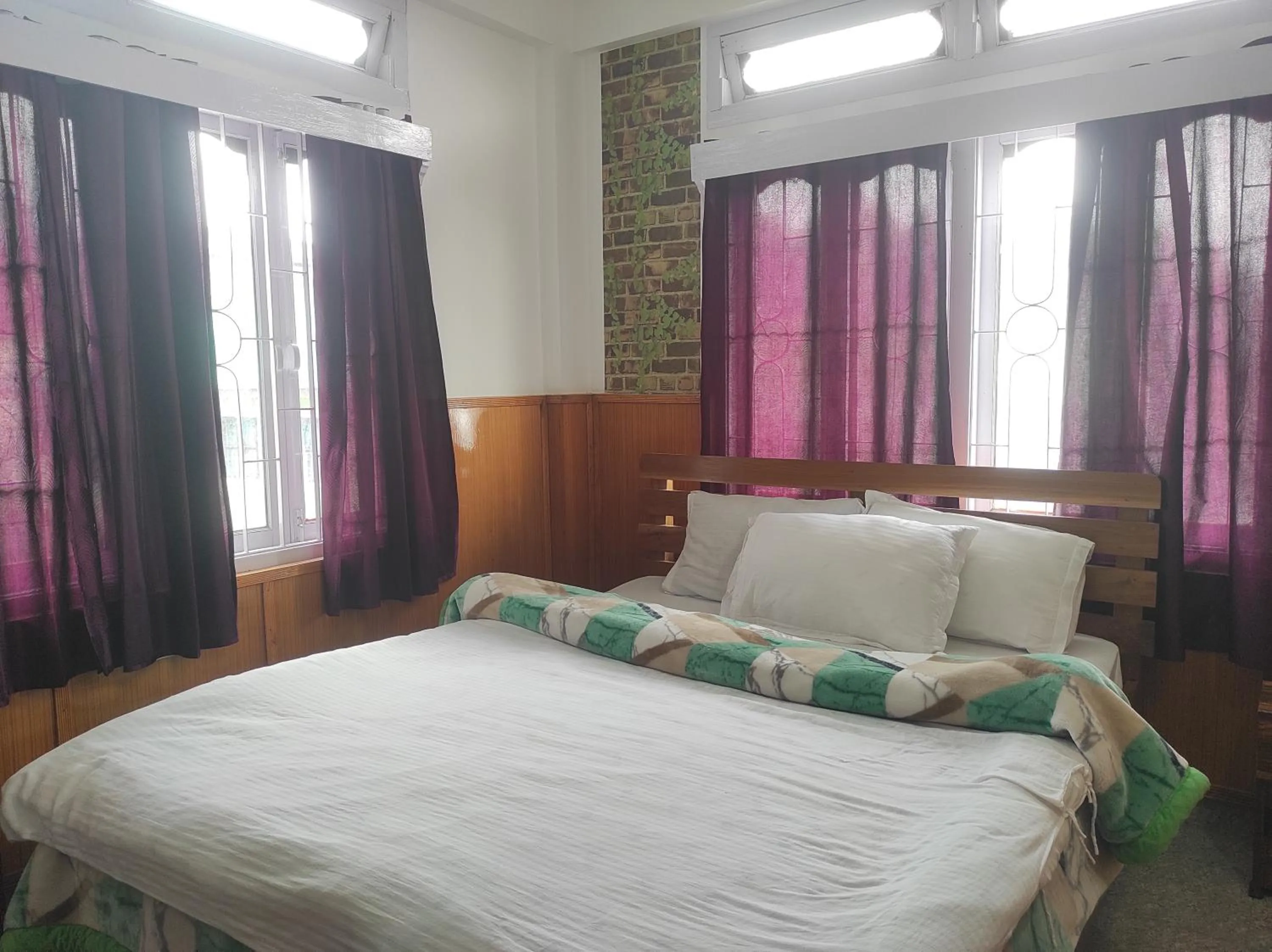 Bed in Hotel Tawang Regency