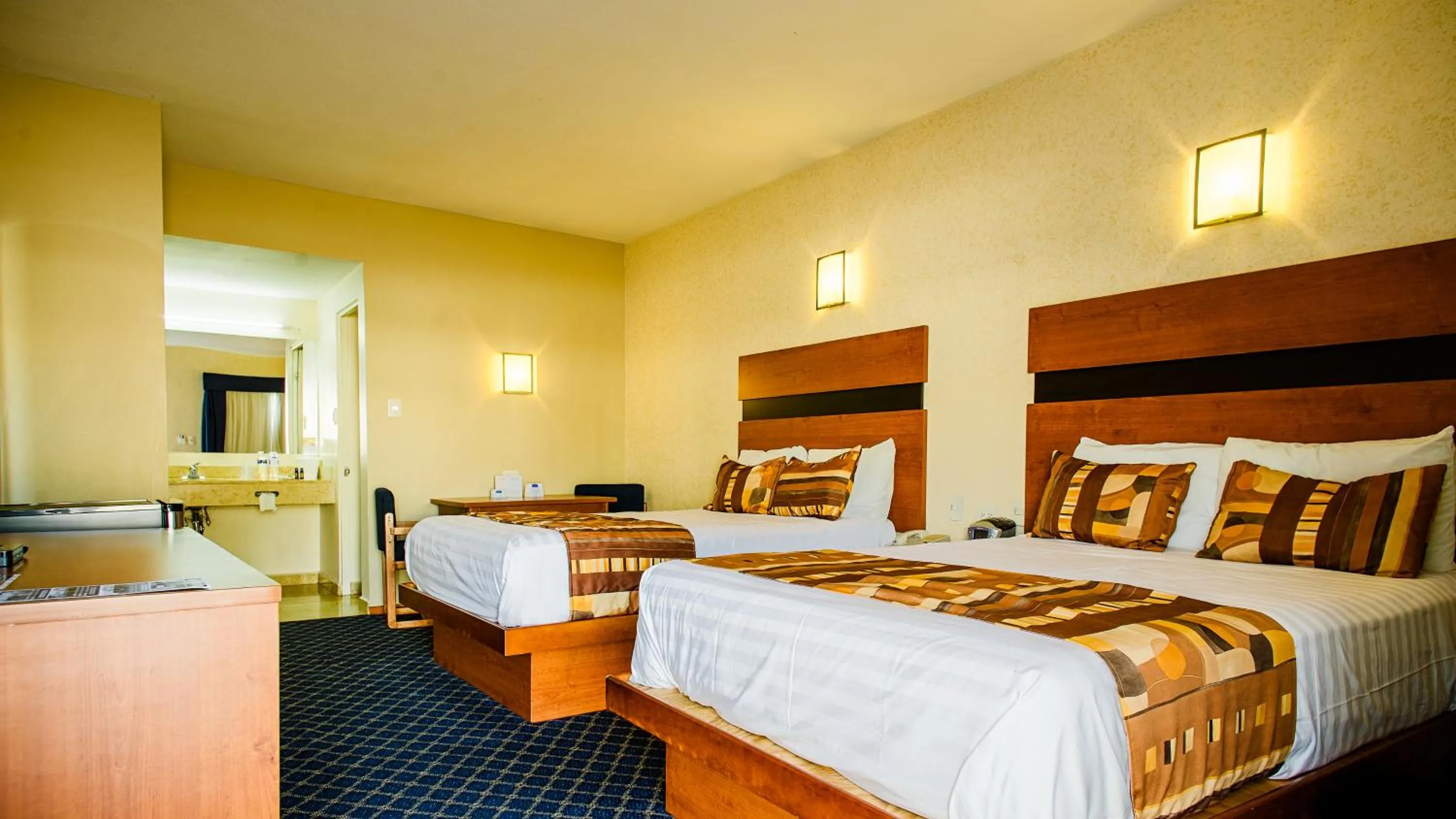 Bed in American Inn Hotel & Suites Delicias