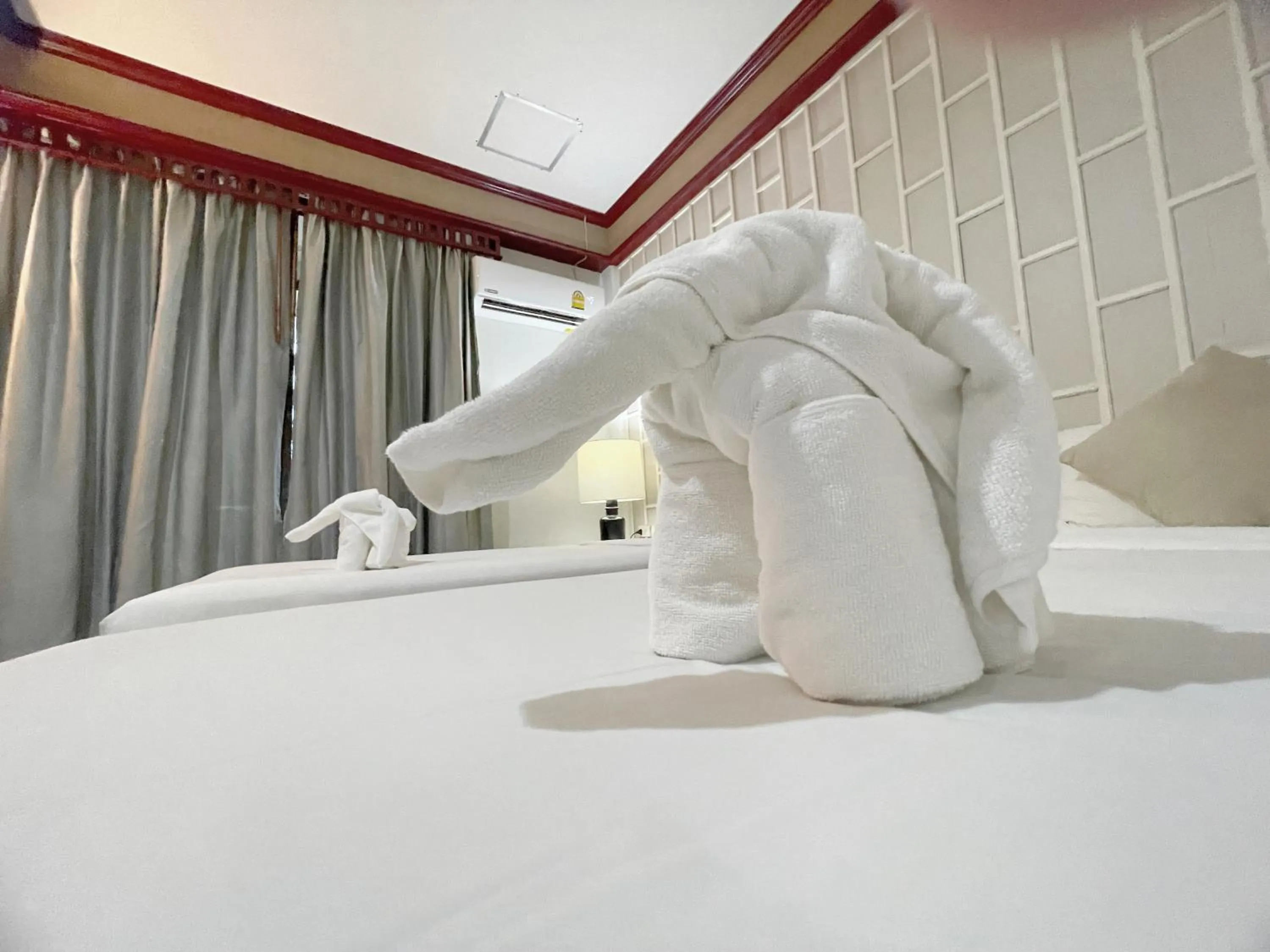 Bed in THE TOP PATONG RESORT.