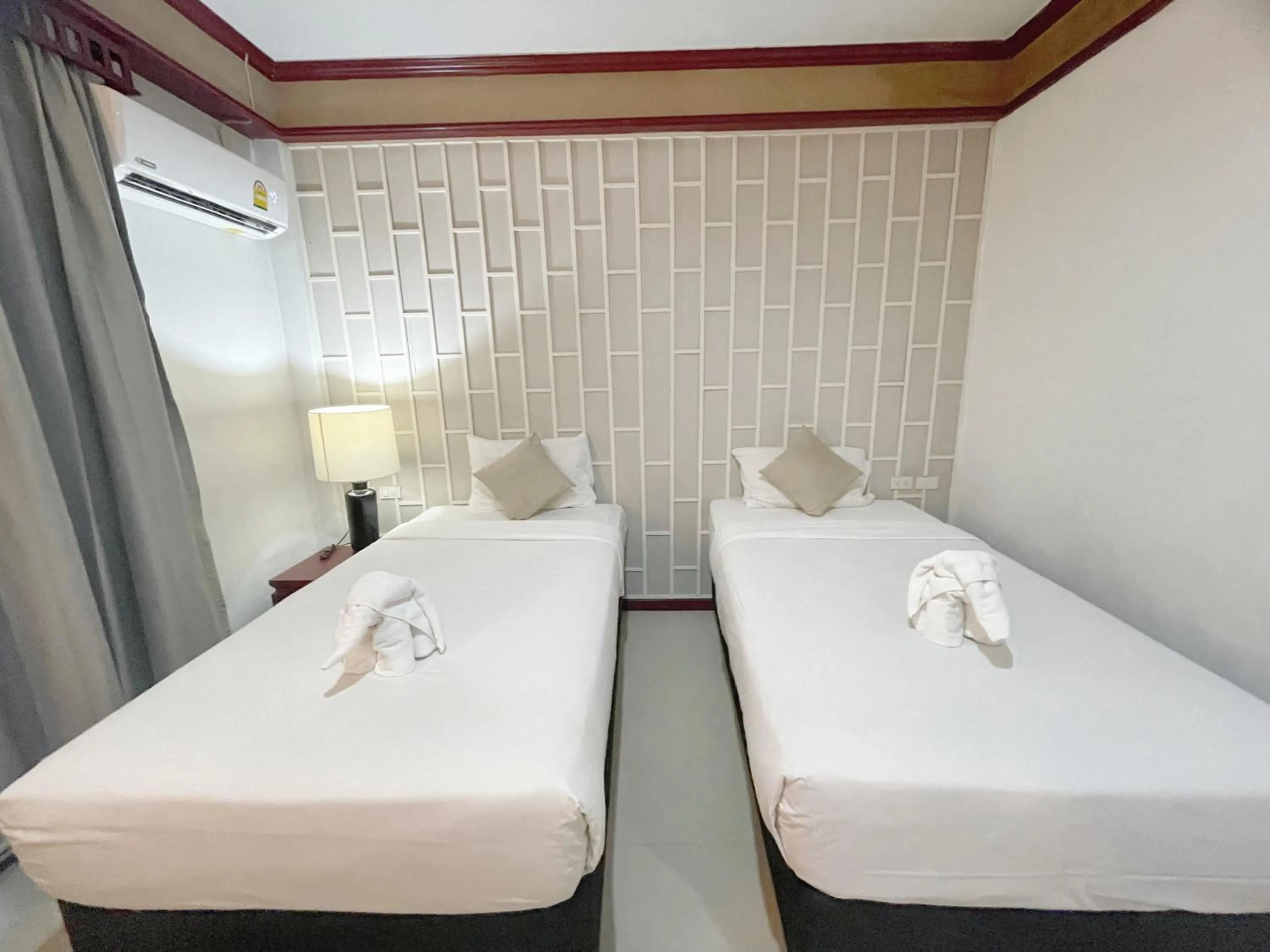 Bed in THE TOP PATONG RESORT.