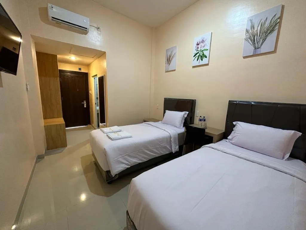 Bed in GRAND PANDAN HOTEL