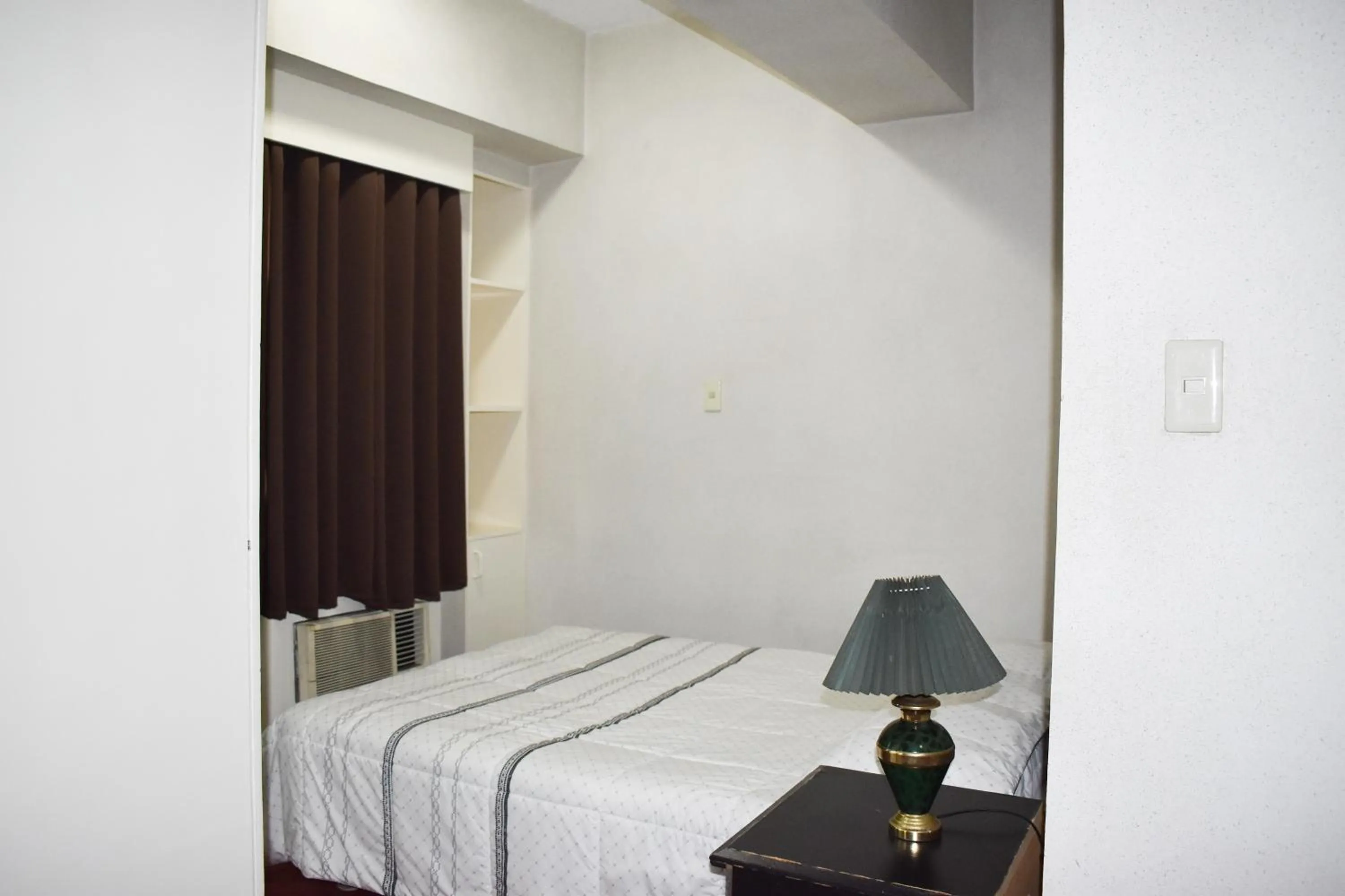 Bed in Sunette Tower Suites Makati City Center