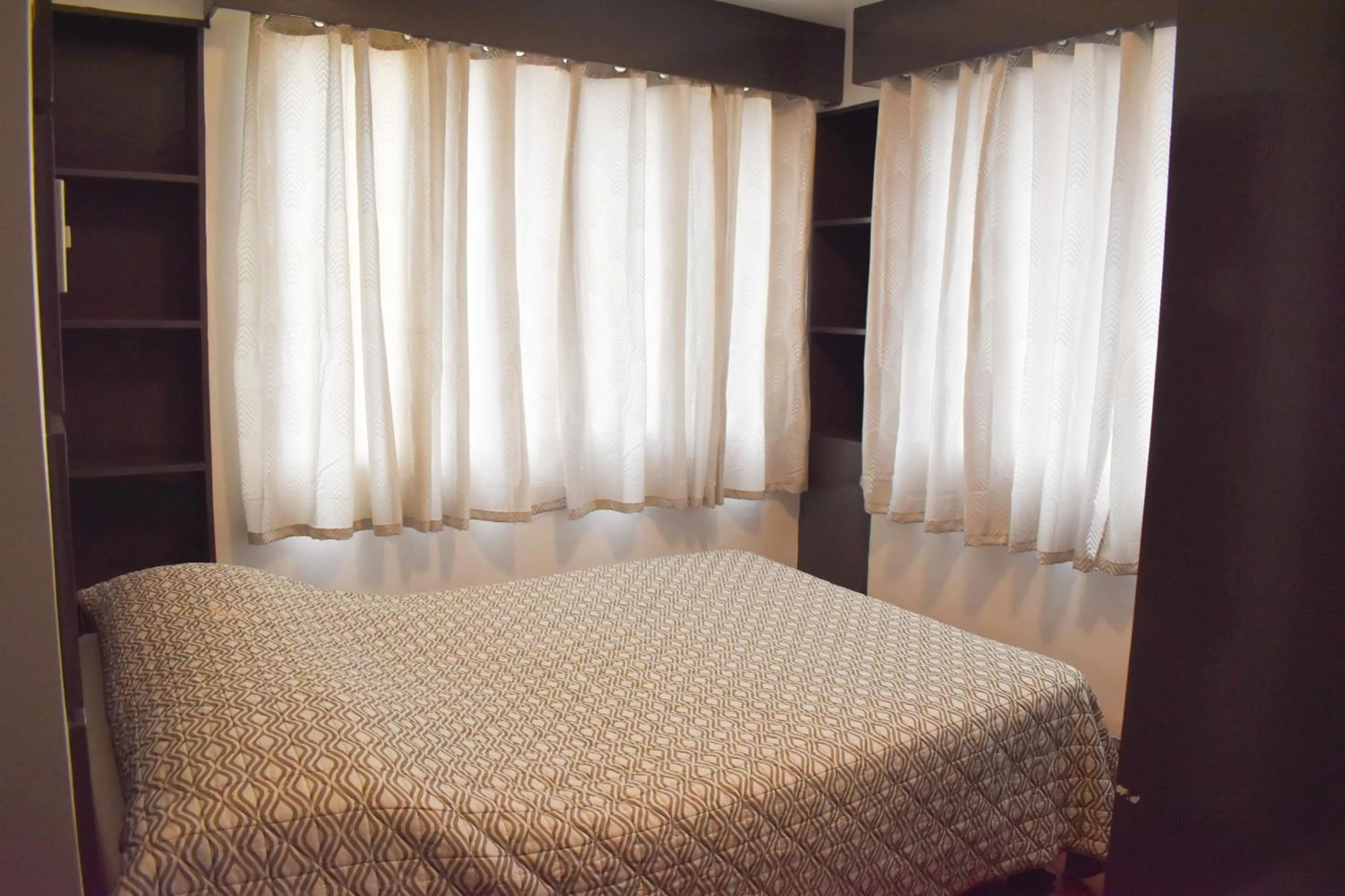 Bed in Sunette Tower Suites Makati City Center