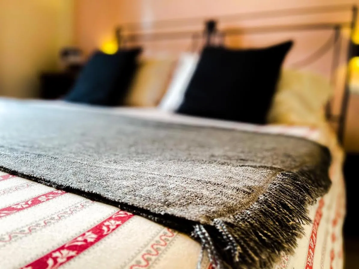 Bed in Charming Bellagio Boutique Hotel