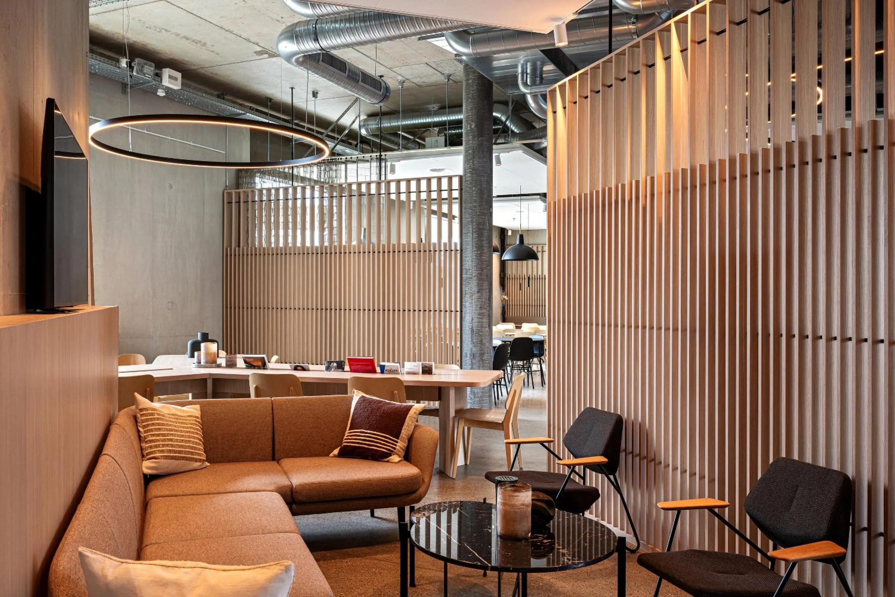 Communal lounge/ TV room in Zleep Hotel Lausanne-Chavannes