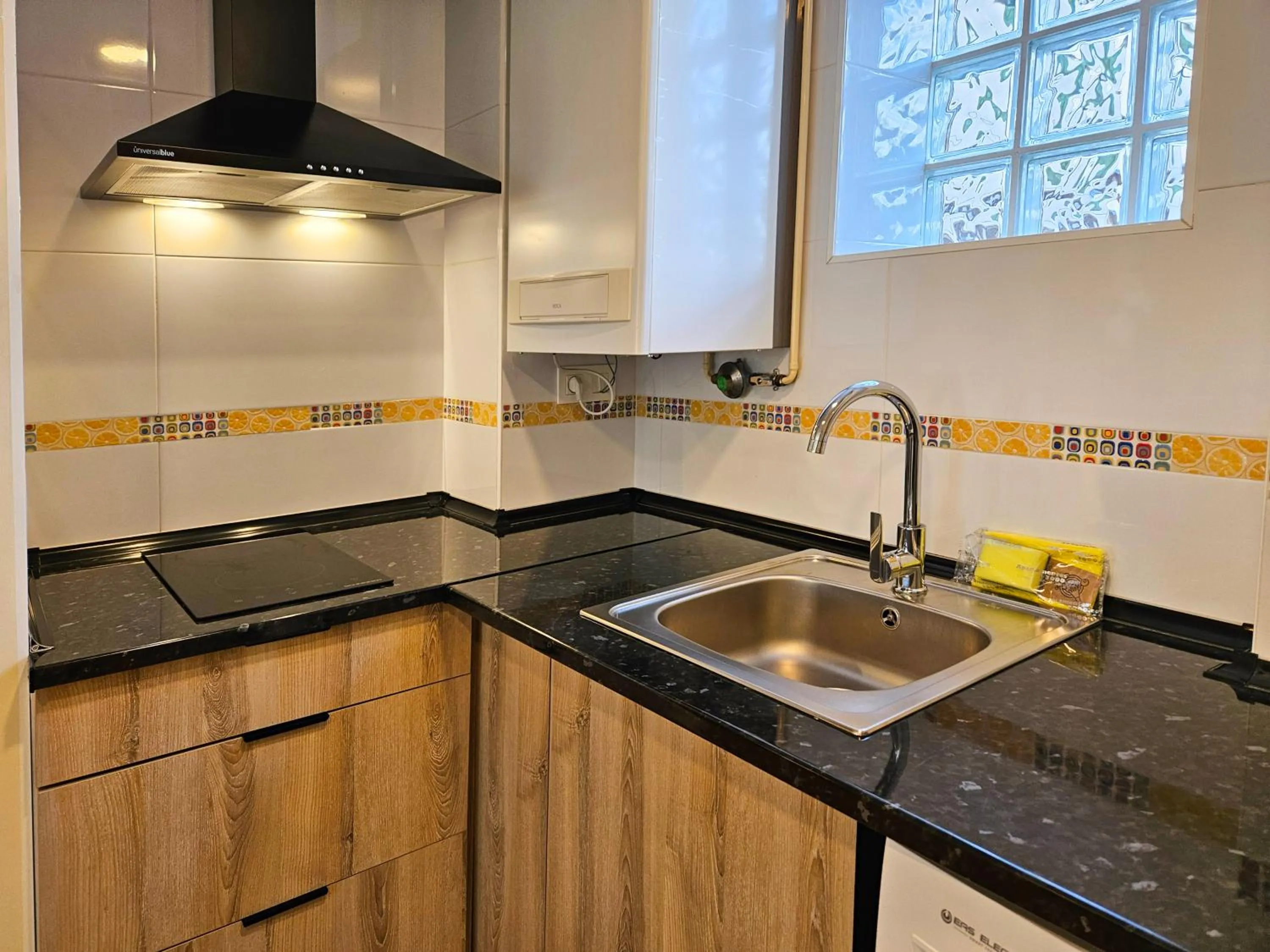 Kitchen or kitchenette in Apartamentos Escarrilla Suites 3000
