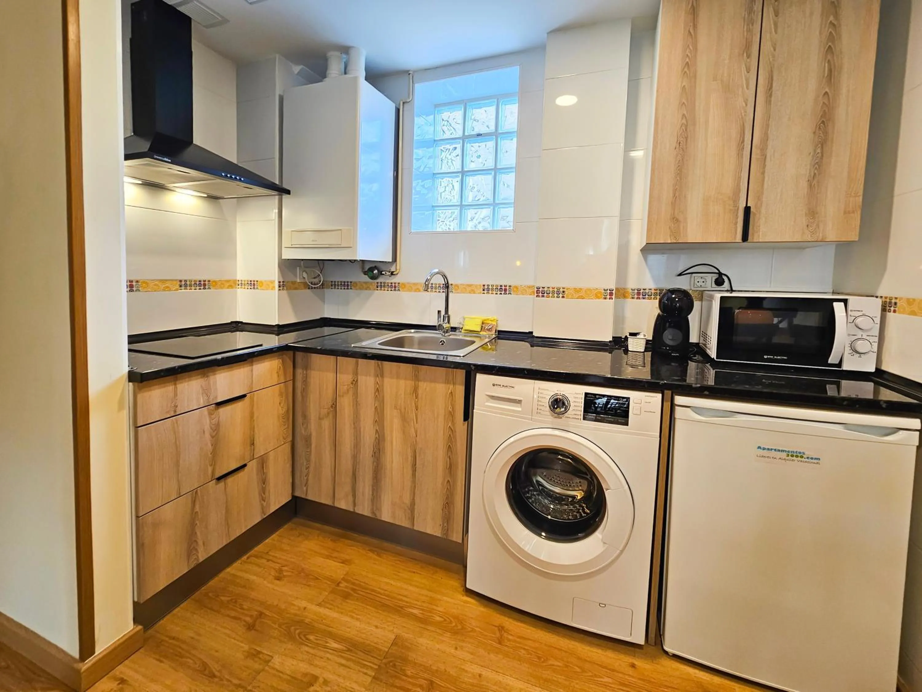 Kitchen or kitchenette in Apartamentos Escarrilla Suites 3000