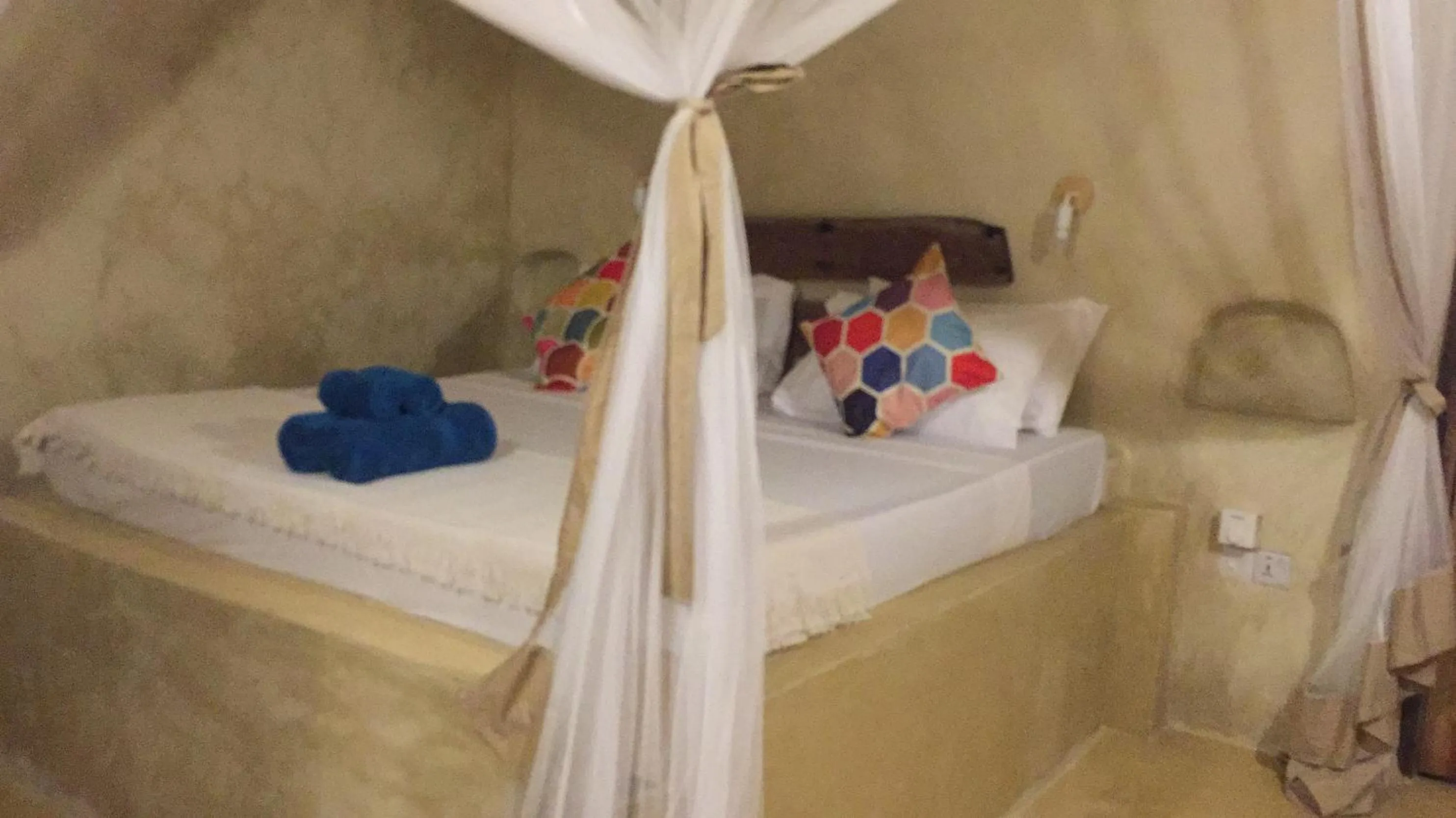 Bed in Bahari Beach Bungalows