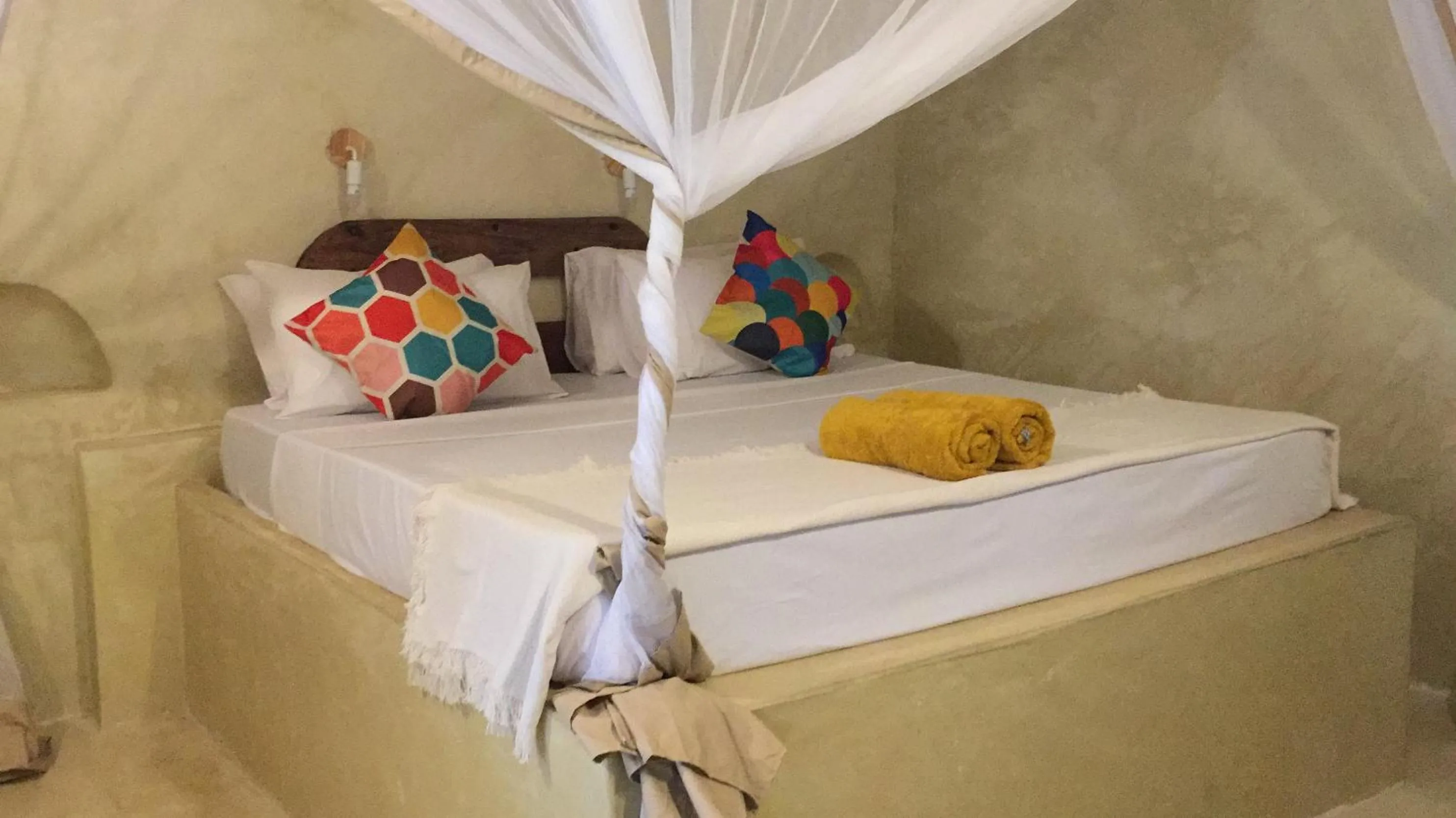 Bed in Bahari Beach Bungalows