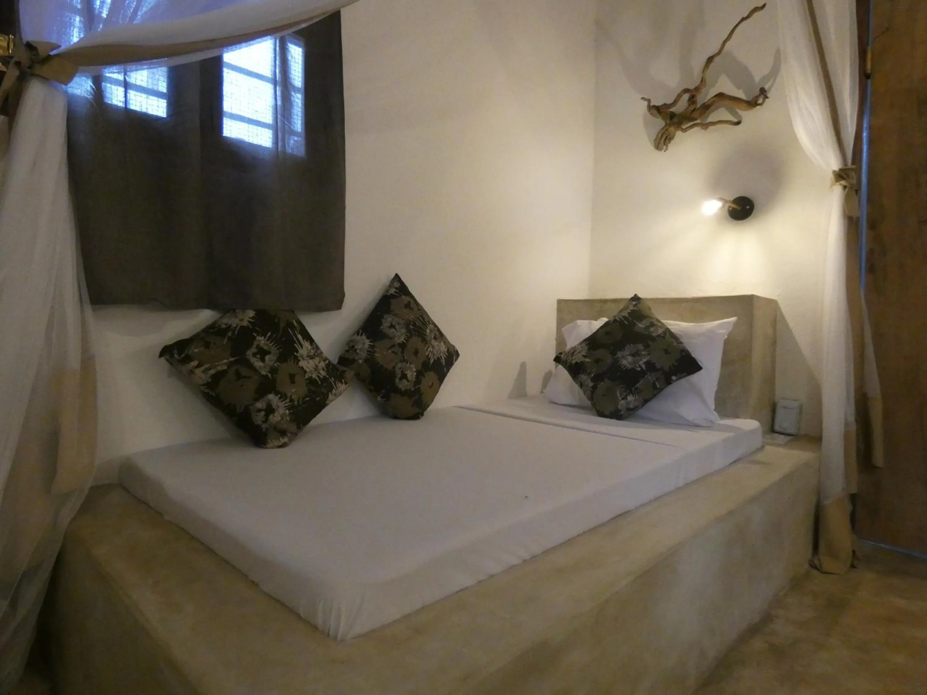 Bed in Bahari Beach Bungalows