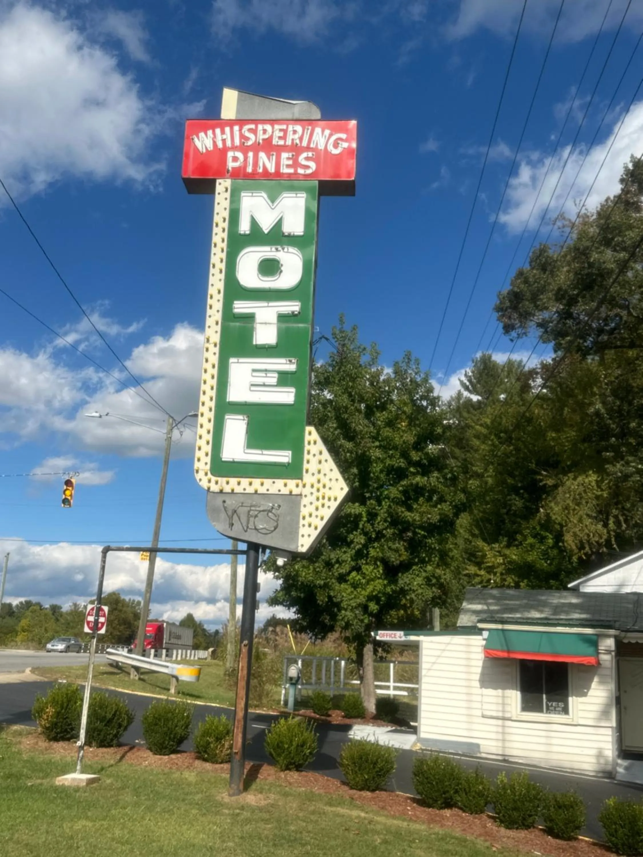 Property logo or sign in Whispering Pines Motel