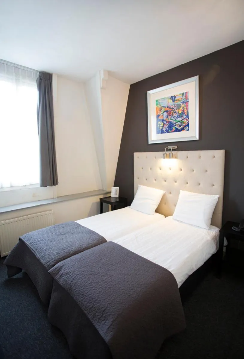 Bed in Quentin Amsterdam Hotel