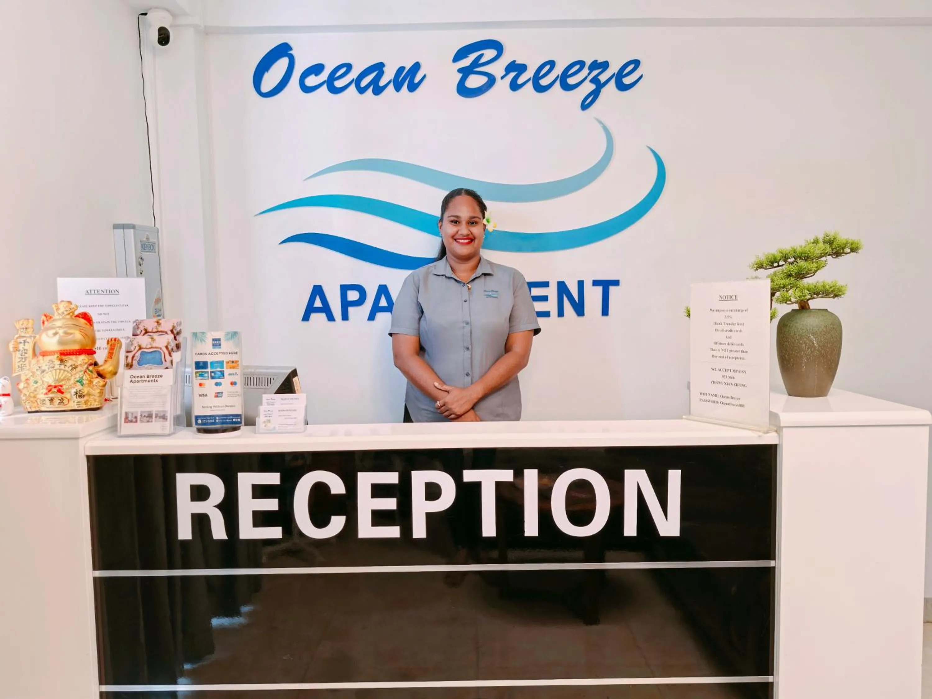Property logo or sign in Ocean Breeze Apartment Hotel