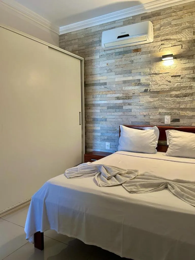 Bed in Pousada Refúgio Jardim de Canoa by Borboleta