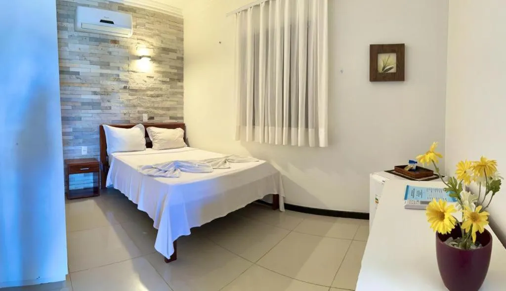 Bed in Pousada Refúgio Jardim de Canoa by Borboleta