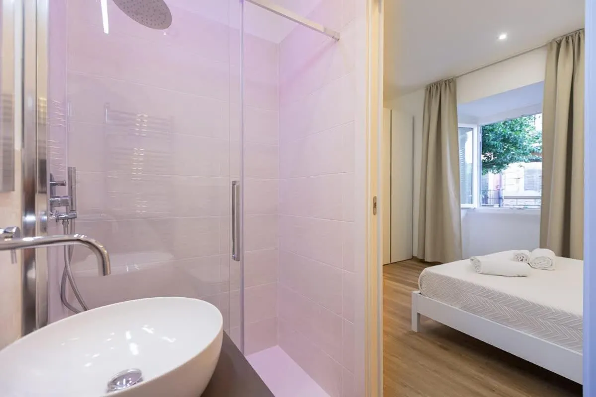 Bed in Colosseum Holidays - Three-Bedroom Apartment