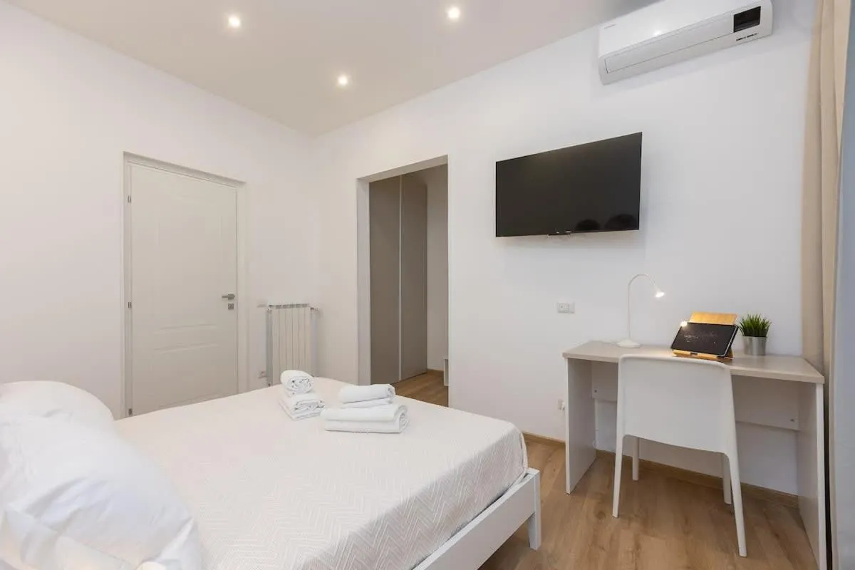 Bed in Colosseum Holidays - Three-Bedroom Apartment