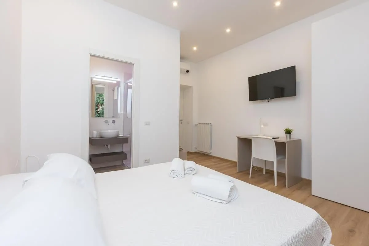 Bed in Colosseum Holidays - Three-Bedroom Apartment