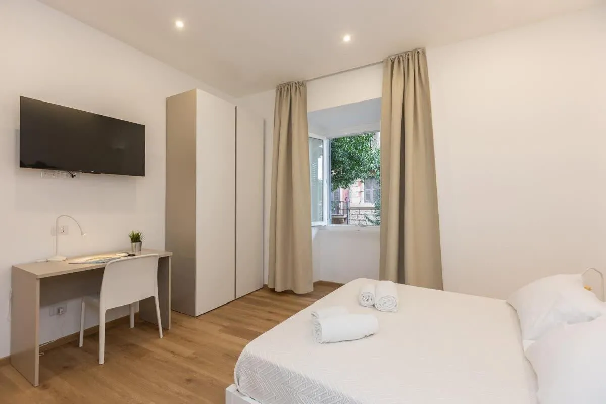 Bed in Colosseum Holidays - Three-Bedroom Apartment