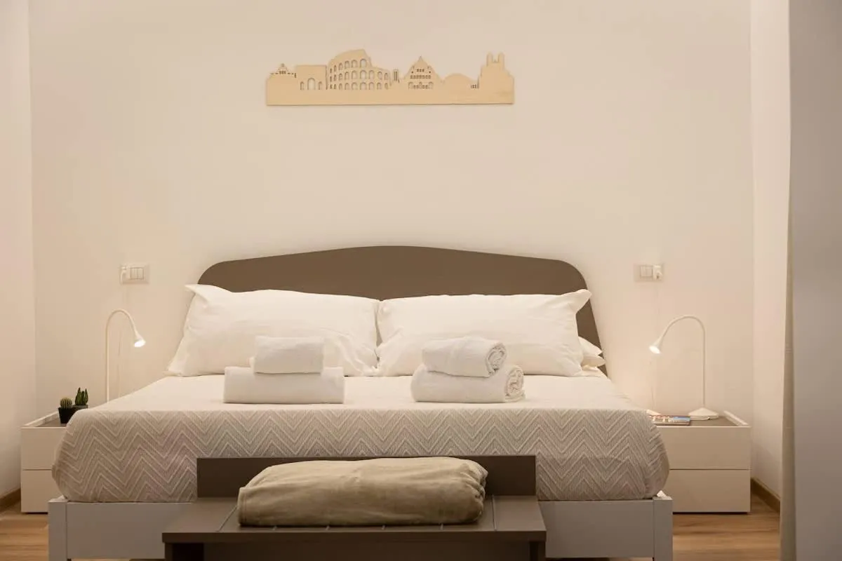 Bed in Colosseum Holidays - Three-Bedroom Apartment