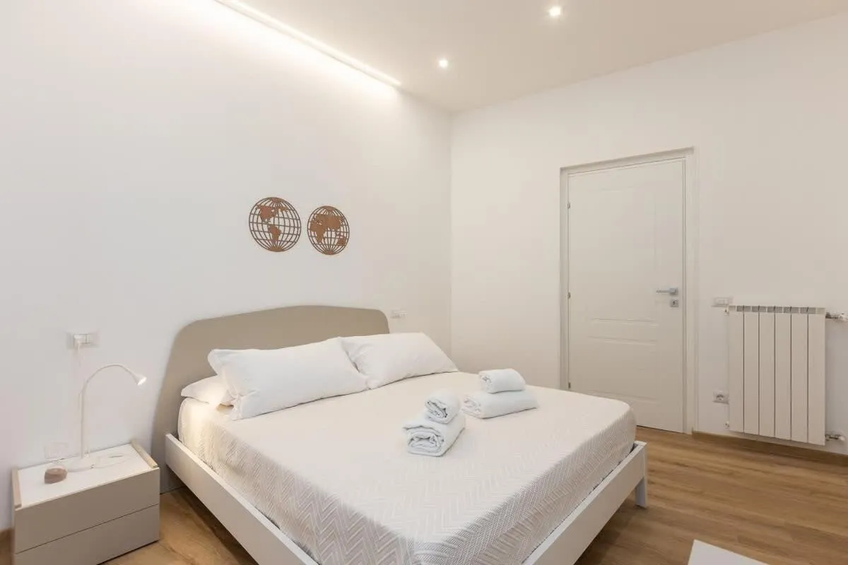 Bed in Colosseum Holidays - Three-Bedroom Apartment