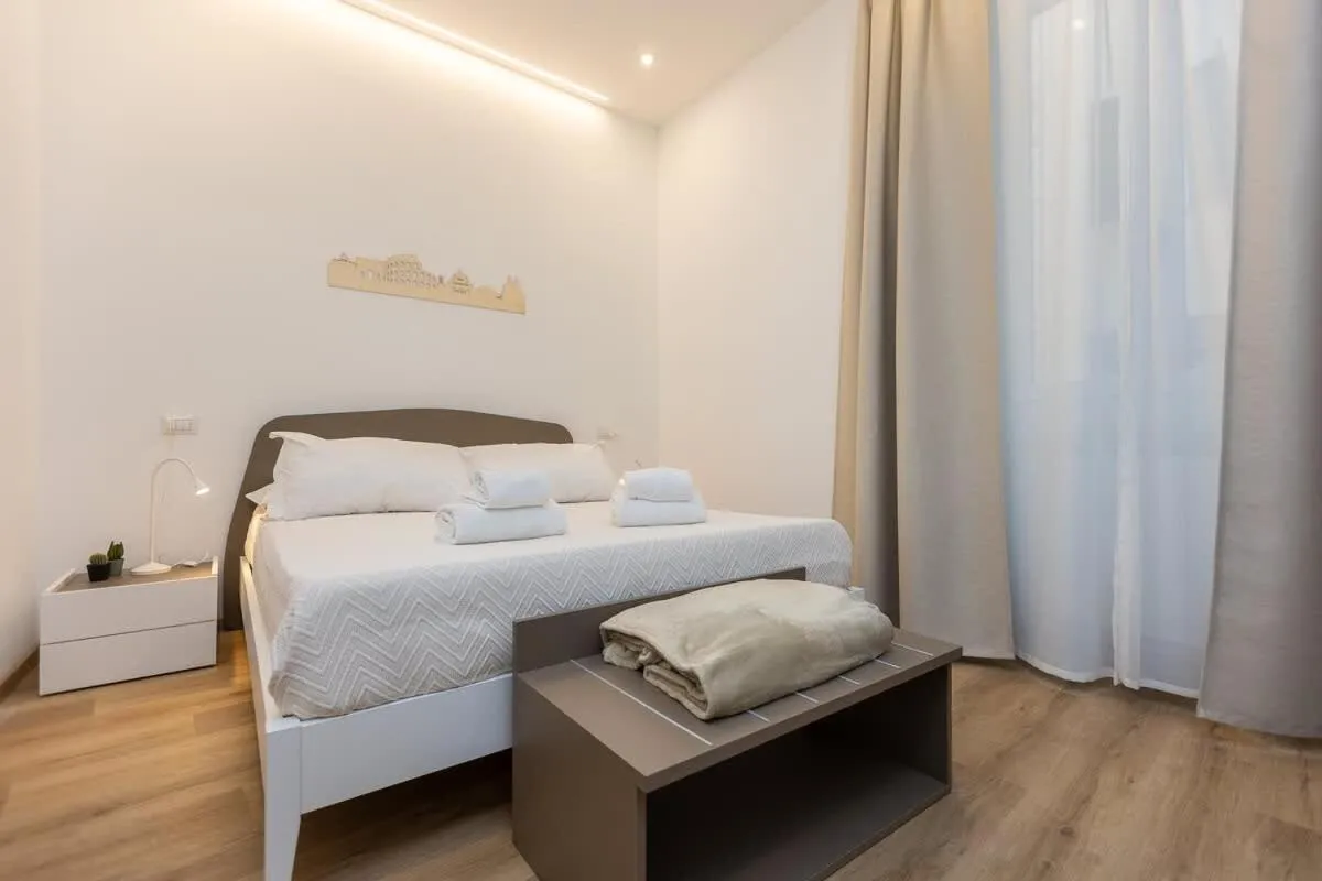 Bed in Colosseum Holidays - Three-Bedroom Apartment