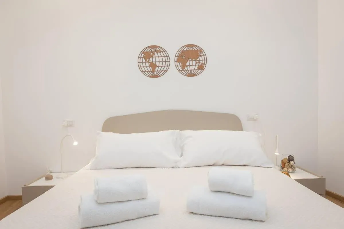 Bed in Colosseum Holidays - Three-Bedroom Apartment