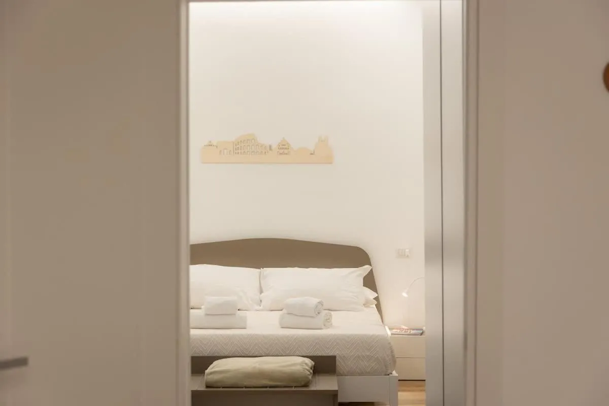 Bed in Colosseum Holidays - Three-Bedroom Apartment