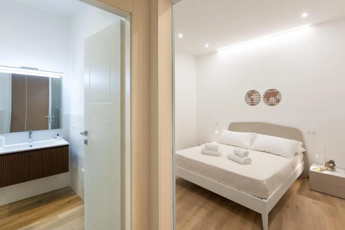 Bed in Colosseum Holidays - Three-Bedroom Apartment