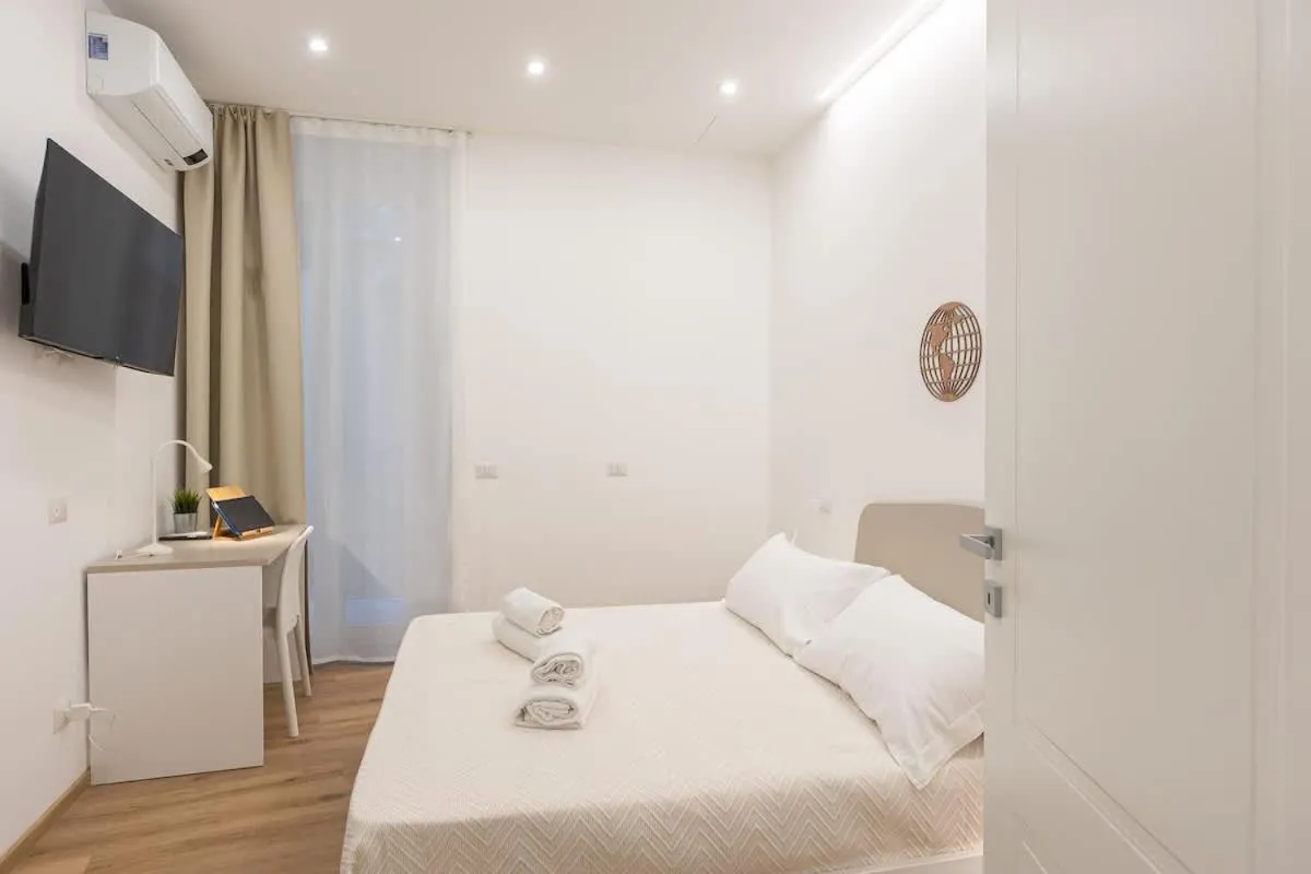 Bed in Colosseum Holidays - Three-Bedroom Apartment